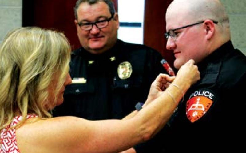 David Smith is pinned by his mother, Jamie Angle.