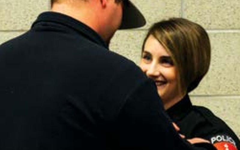 Cushing Police Officer Sara Reynolds, is pinned by her boyfriend, Dalton Armstrong, during a swearing-in ceremony held at the Cushing Public Safety Center. Reynolds and newlyhired officer David Smith, were both sworn in and pinned during a virtual/live event last week.