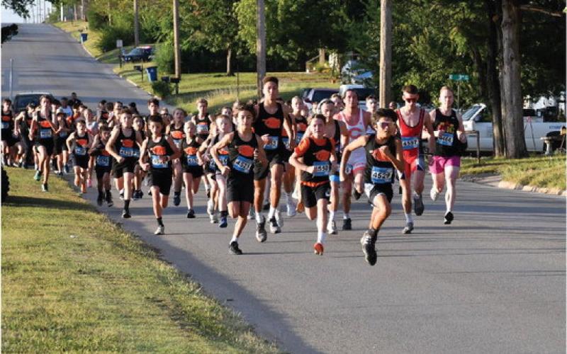Members of the Cushing Tiger Cross Country team dominate the start of the Grappler’s Gallop Saturday, at Memorial Park. Photo by Sarah Townes