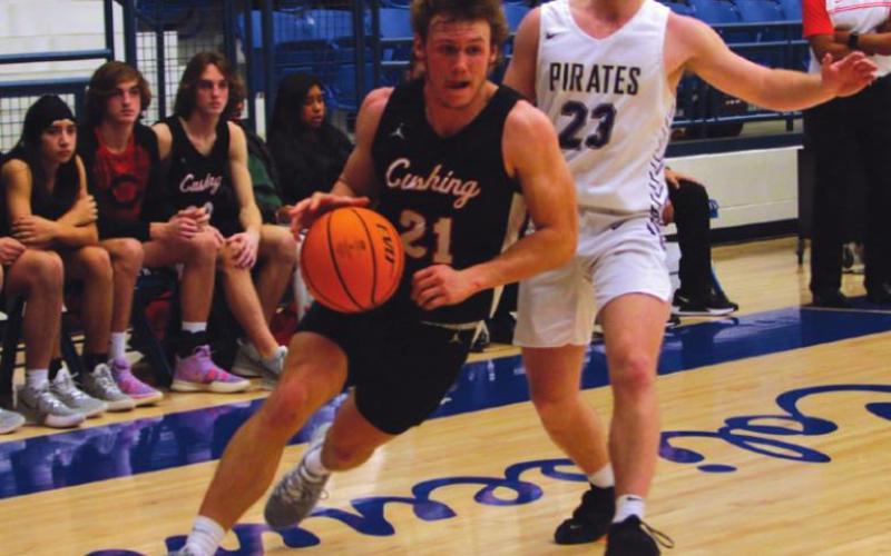 Camden Crooks dribbles off the three-point line and goes to the bucket.