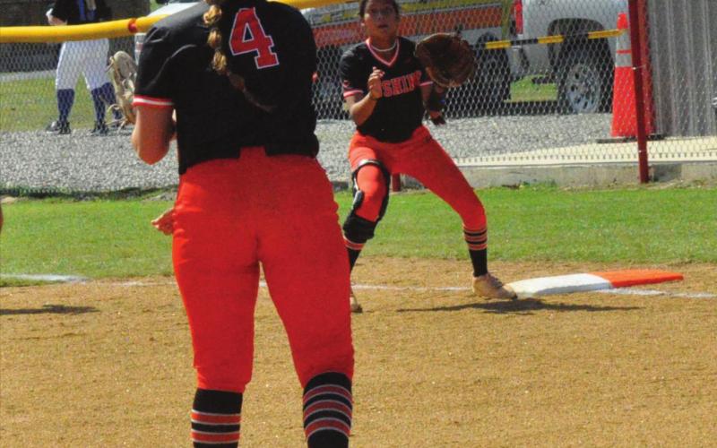 Pitcher Katy Jones makes a throw to Morgan Franklin at first.