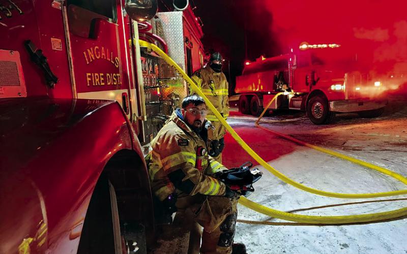Right: Members of the Ingalls Volunteer Fire Department man the pumper during a fire that broke out in Ripley on Monday.