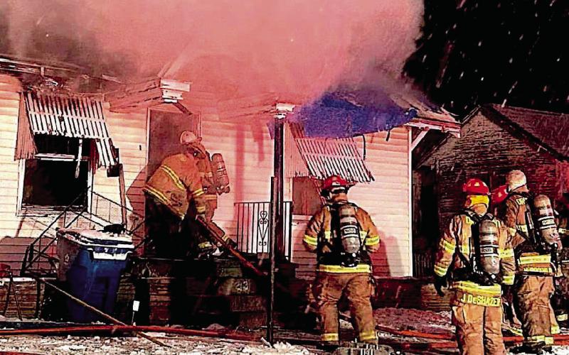 Brett Lunsford and Lucas Andrews makes their way into the primary structure followed by department members Austin Riley, Jesse DeShazer, and Nick Rockhold as billows of smoke ascend and snow descend.