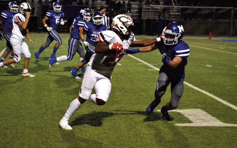 Noah Jones puts the defender in the turf with a stiffarm on his way to the endzone in Cushing's 54-13 win over Miami. Photo by Kaleb Tadpole
