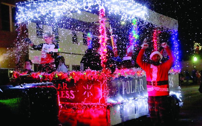 Cushing Wal-Mart associates celebrate their win of Mayor’s Choice in front of the grandstands during the Cushing Christmas Parade Saturday, Dec. 14. Photo by Allie Prater