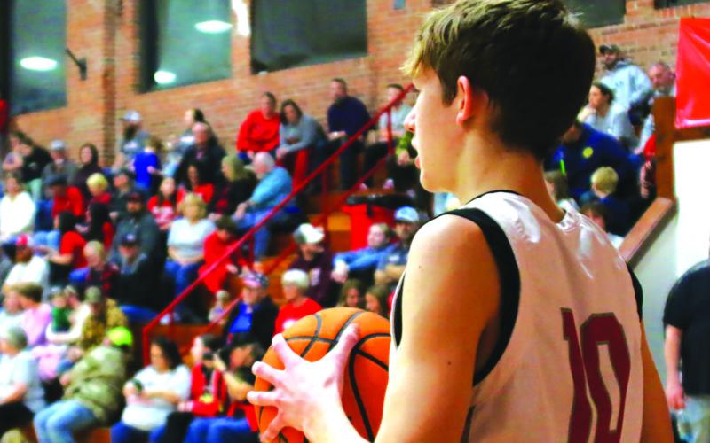 Sophomore Tornado Keaton Jensen looks to inbound the ball in front of a packed house during “I Played at the Brick” night last Friday. All Tornado alumni who played at Drumright’s historic arena were invited to be a part of the final high school basketball game to be played in The Brick and they responded, packing the house with a standingroom-only sea of red. Photo by J. D. Meisner