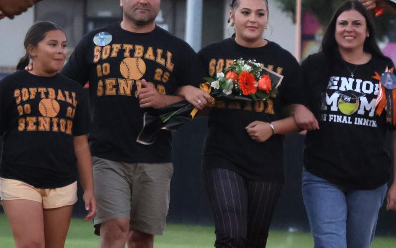 Faith Kesler walks with her parents Mary and Tony Kesler and her little sister Riley for senior night. Photo by Sylvia Danyele