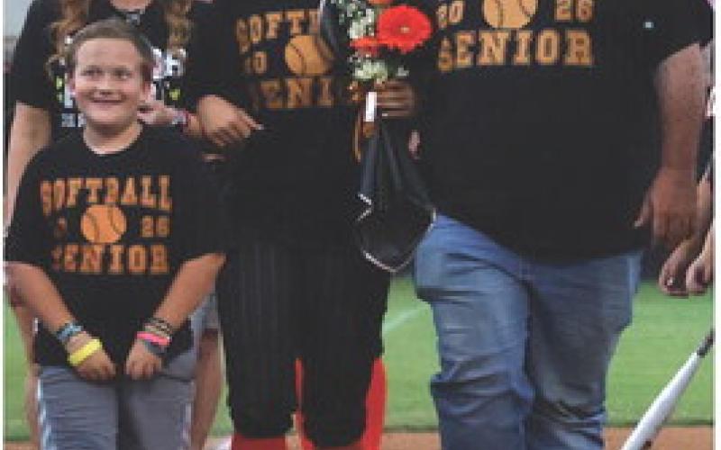 Gracyn Presley walks with her parents Scott and Destiny Presley and her little brother Gideon Presley for senior night. Photo by Sylvia Danyele