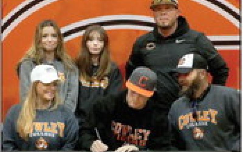 Jake Horn signs his letter to play baseball for Cowley University.