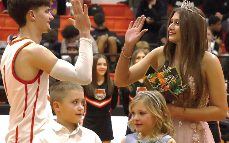 2026 CHS homecoming King Roman Tucker and Queen Tirzah Wade high five after being crowned CHS Basketball Royalty. See inside for more. Photo by Sylvia Danyele.