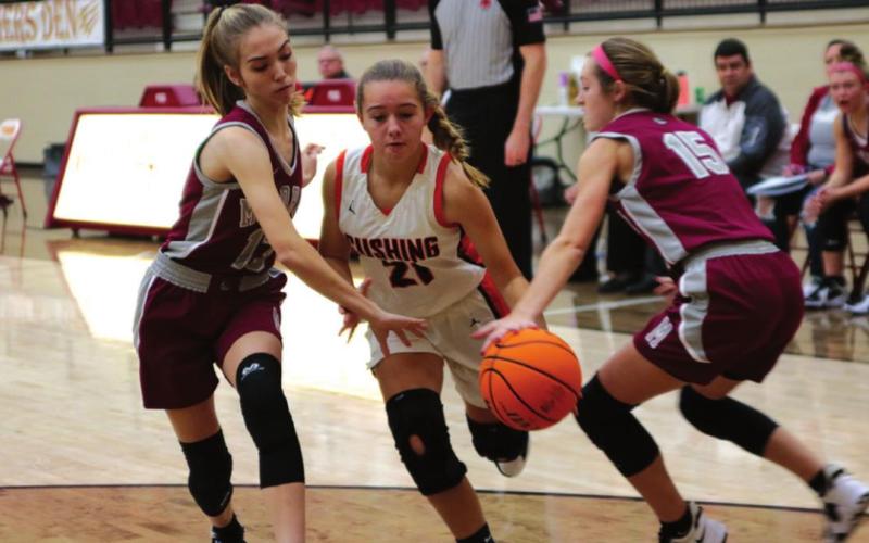 Katelynn Powell splits a pair of Muldrow defenders Thursday night in Cleveland.