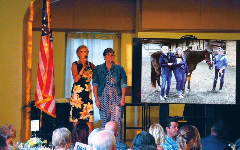 Leslie Kirkland stands hand in hand with Julie Jones as she thanks her for putting in so much time and effort into her work at The Right Path and in coordinating the 25th Anniversary Fundraiser Gala on Saturday, July 24.