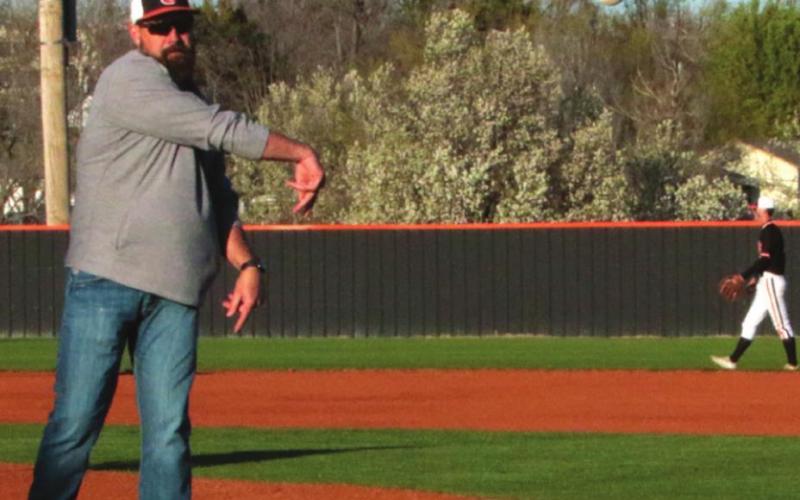 Former Tiger hurler Paul Porter throws in the fi rst pitch last week prior to the Cushing Tiger’s baseball game against the Chisholm Longhorns. Several alumni attended the game and were recognized prior to the opening pitch. Photo by J. D. Mesiner