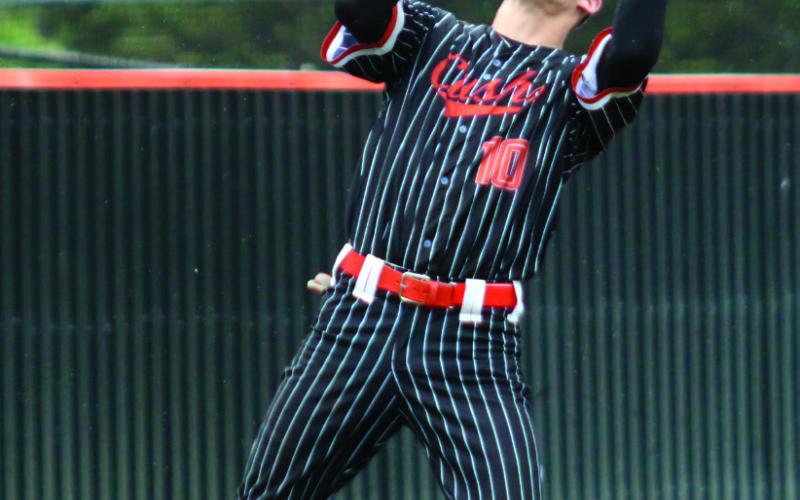 Beau Roe lays a textbook bunt down the first base line. Photos by Allie Prater Riley Matheson gets one of two hits collected in the first game of the Stetson Hendron gets under a pop fly. regional tournament against the Inola Longhorns.