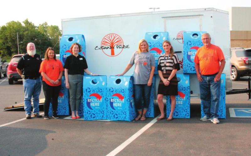 From left stands Chris Hubbard, Laura Green, Dr. Melissa Amon, Brook Holcomb, Jessica Wood, and Richard Thackray with the recycle lend bins that will be dispersed across the Cushing Public Schools property in an eff ort to promote recycling.