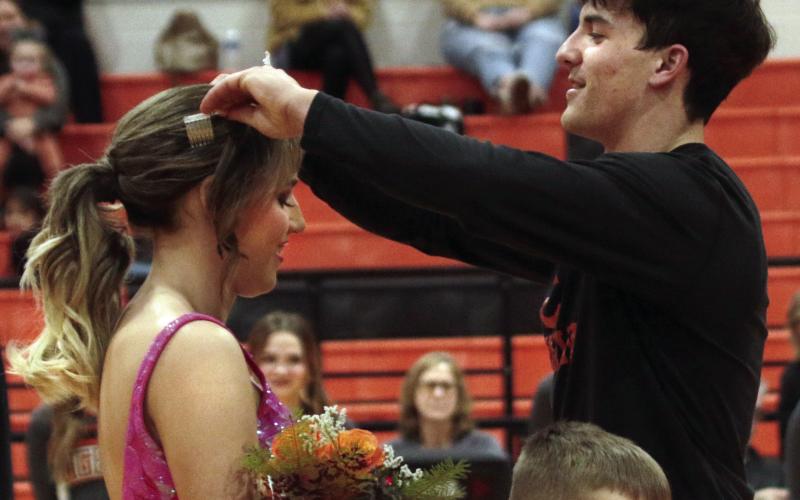Blaze Berlowitz crowns Cushing 2023 Homecoming Queen Tatum Caulfield during the coronation ceremony at halftime Friday, Jan. 13.