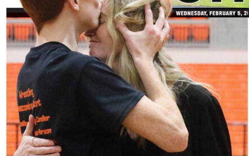 CHS Wrestling senior Owen Collier gives his mom Annie Collier a kiss on the forehead during the CHS Wrestling Senior Night festivities Tuesday, Jan. 28. Photo by Allie Prater