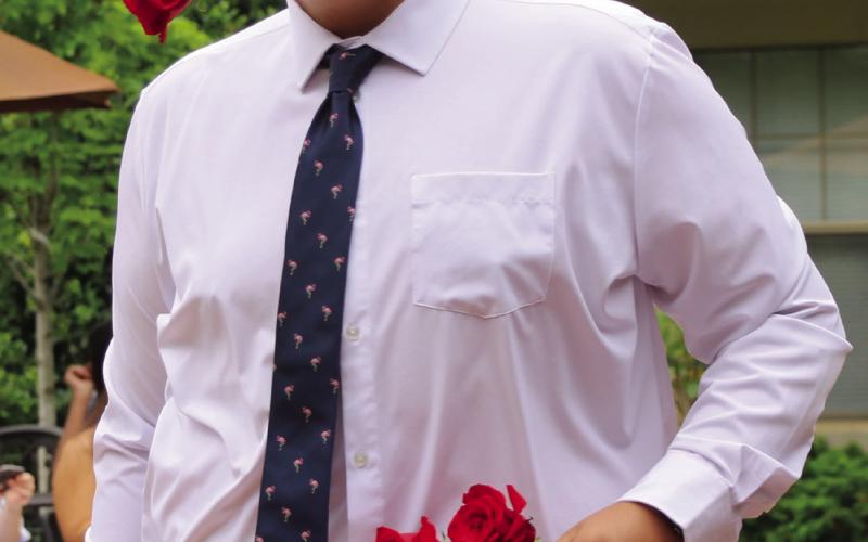 “Lady’s Man” Tyler Norman struts down the runway, roses ready for his next lady.