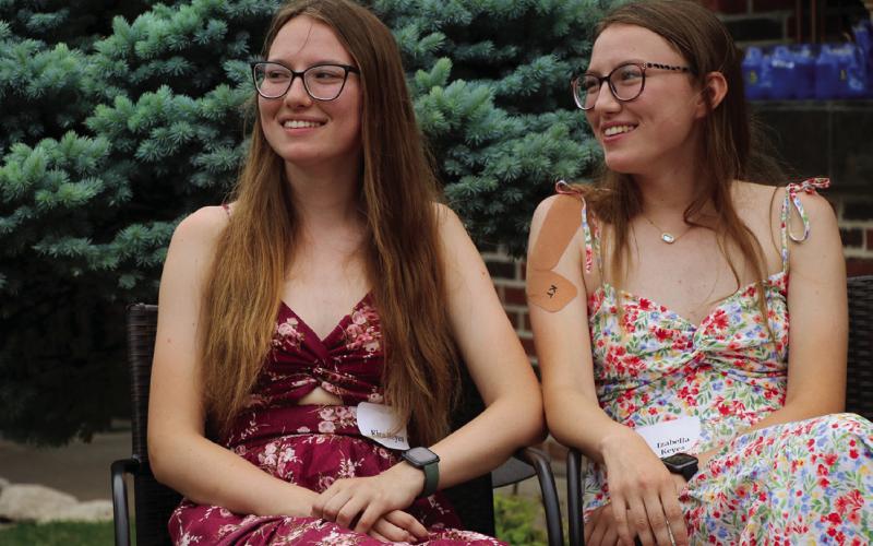Sisters Kira and Bella Keyes watch the fashion show during Senior Tea.