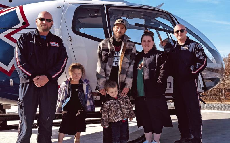 Myles Dobson and his family recently visited the MedFlight crew who transported and provided critical care to him during a flight from Stroud to OSU Medical Center in Tulsa recently. Pictured with Dobson and his family are flight nurse Matt George and Flight Paramedic Chase Boyd.