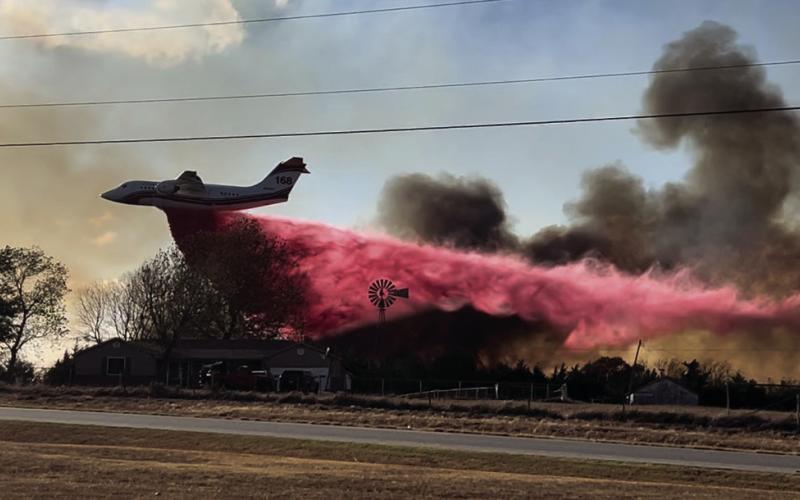 A tanker plane drops Phos-Chek, a fertilizer-based liquid and fire suppressant, on the flames near Schlegel Road. Photo courtesy Jordan Stebens