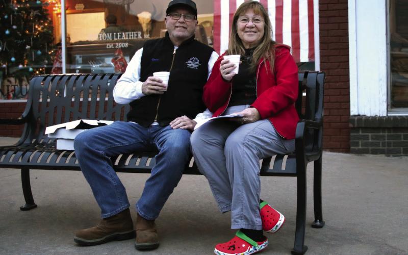 Jim and Shellie Walker enjoy a cup of hot apple cider during the inaugural Downtown Cushing Revitalization Association (DRCA) Cookie Crawl held Tuesday, Dec.12. Seventeen businesses participated in the Cookie Crawl and 92 boxes of cookies were sold. Photo by Allie Prater