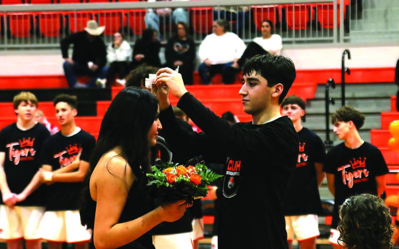 CHS Basketball Homecoming King Kanaan Guerrero places the crown atop the head of Homecoming Queen Ella Nanaeto