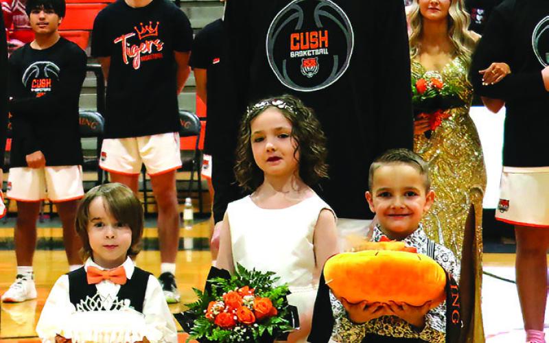 Senior Max Wood escorts crown and Sash Bearers Beckett Baade, Emma Chisolm and Bison Townes.