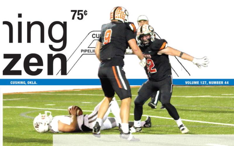 Cushing defensive tackle Connor Moreland and outside linebacker Jake Horn celebrate a sack of Elk quarterback Austin Jones, Friday, during the Tigers’ 56-14 mauling of Elk City. Cushing’s defense played a pivotal role in the win that propelled the Tigers to the Class 4A state final, which will be played against Wagoner at UCO in Edmond this Saturday at 7 p.m.