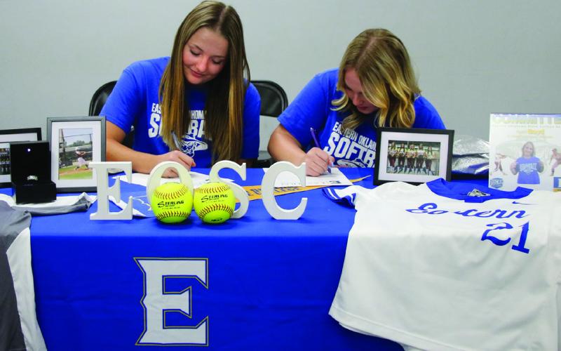 Ripley Lady Warrior softball players Taylor Boyd and Dakota Hall sign their letters of intent to play softball for Eastern Oklahoma State College in Wilburton, Thursday Nov. 9.