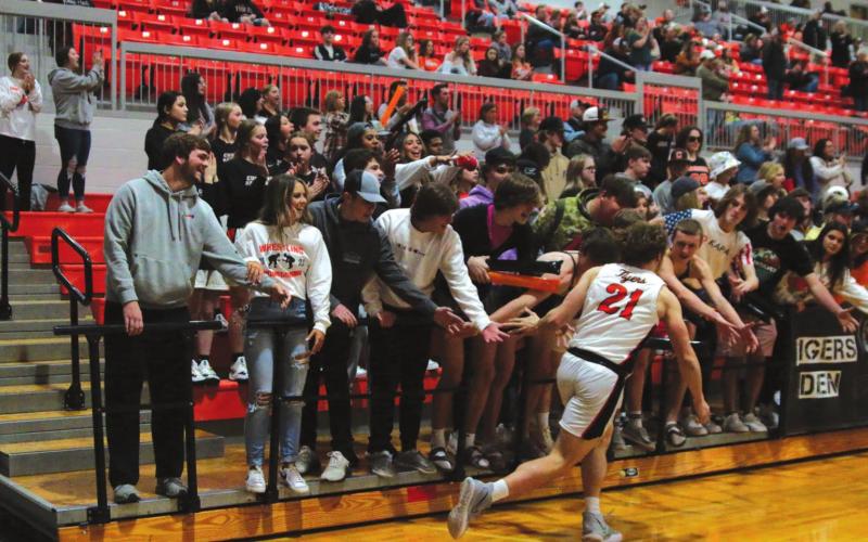Camden Crooks gets a little energy from the student section during introductions on Friday.