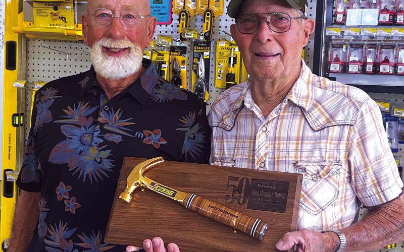 Larry Holderread and Bobby Lofton were recently honored for 50 years of service to Cushing Lumber. Each were awarded a golden hammer. Photo by J. D. Meisner