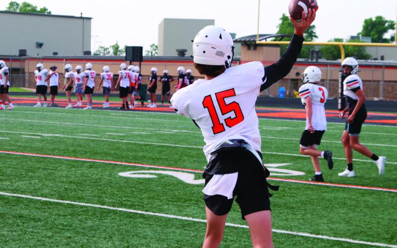 Ethan Evans gets some throws in with receivers at team camp in Cushing on Thursday. Photo by Kaleb Tadpole