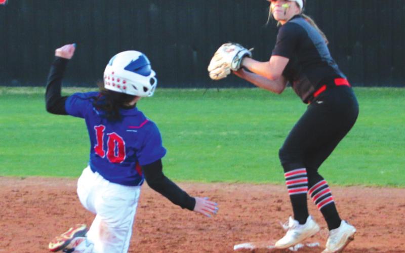 Lady Tiger shortstop Kerik Brown turns a double play from second.