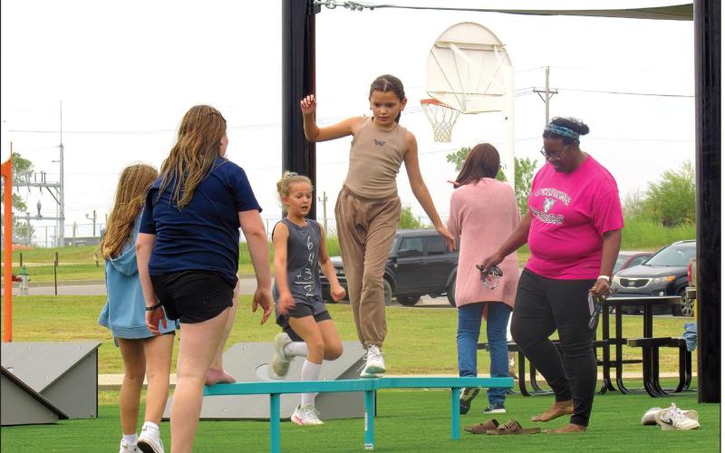 CMS fifth grade students enjoy the new playground equipment at the school building including Bella Craig who was testing her balance with a few encouraging onlookers. Photos by DeAnna Maddox