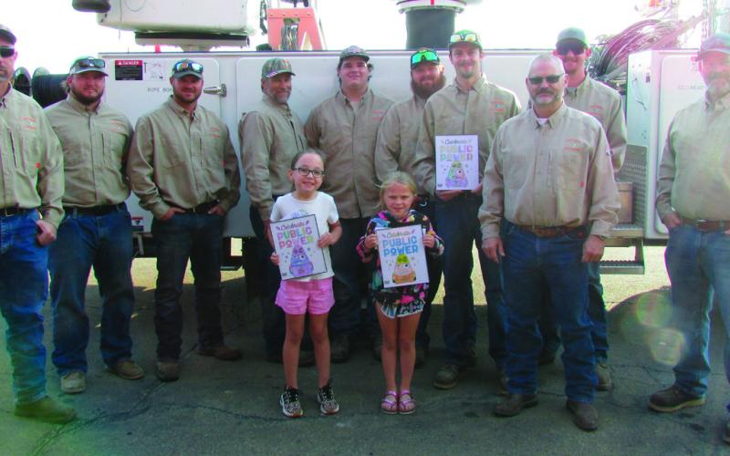 The City of Cushing power distribution team held a coloring contest for the students at Cushing Upper and Lower Elementary. First, second, and third place winners were selected by team members and awarded their prizes last week during Public Power Week. Pictured are city workers Dwayne Abbott, Travis Oaks, Gavin Weatherly, Brendan Campbell, Seth Campbell, Brandon Harris, Sam Rhymer, Josh Moore, Electric Superintendent Mike Stark, and Doug Biswell with the winners of the contest. CUE winners: First place Tat