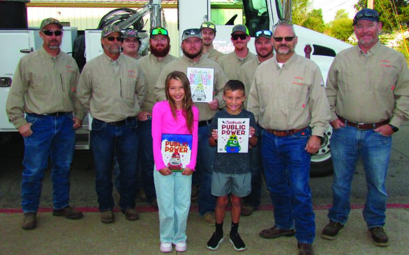 The City of Cushing power distribution team held a coloring contest for the students at Cushing Upper and Lower Elementary. First, second, and third place winners were selected by team members and awarded their prizes last week during Public Power Week. Pictured are city workers Dwayne Abbott, Travis Oaks, Gavin Weatherly, Brendan Campbell, Seth Campbell, Brandon Harris, Sam Rhymer, Josh Moore, Electric Superintendent Mike Stark, and Doug Biswell with the winners of the contest. CUE winners: First place Tat