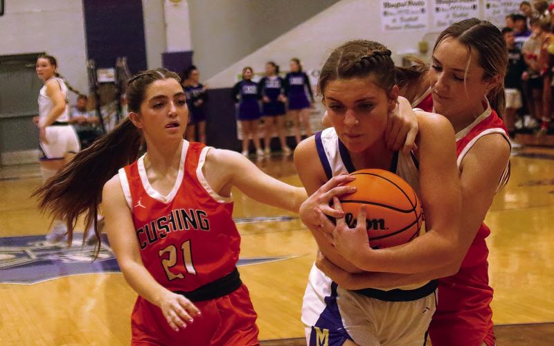 Emery Turner battles for possession as Mya Bridgeman comes in to help.