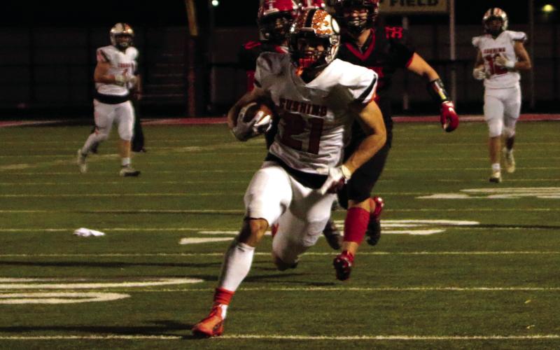 Senior Camden Crooks returns a punt for a touchdown Friday.