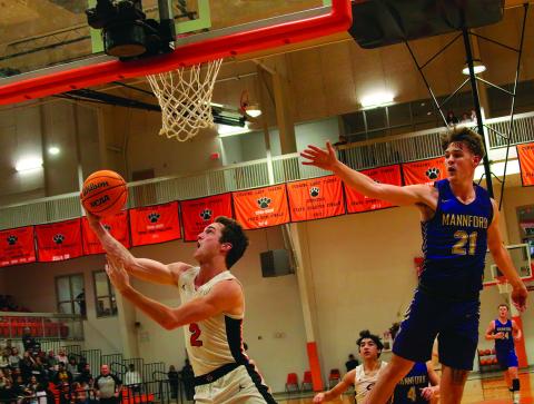 Lane Wood makes a reverse layup. Photos by J. D. Meisner