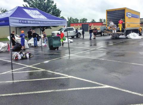 Volunteers at the first recycling event sort through items that have been dropped off.