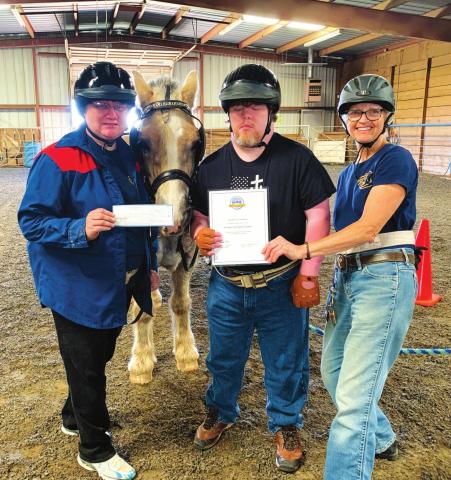 Holly Hulsey, Michael Lawrence and Right Path Founder Leslie Kirkland display the new helmets provided through a grant from MFA Oil Foundation.