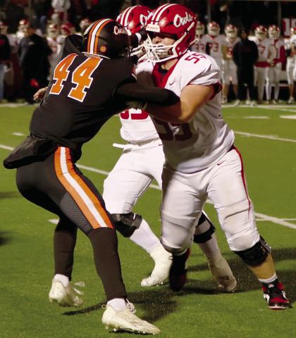 Hunter Joiner stands off with two Elgin defenders during Friday’s semi-final game at Putnam City. Photo by Sylvia Danyele
