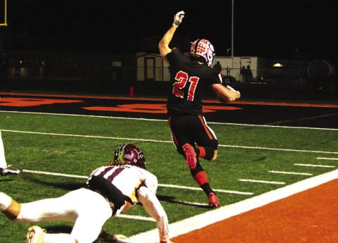 Senior Camden Crooks keeps his balance and stays in bounds during a 30- yard scamper into the endzone.