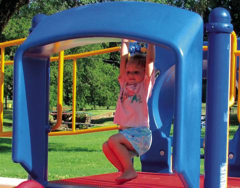 Sophie Hoover took a moment to swing before launching herself down a slide.