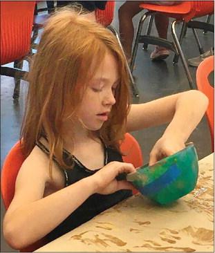 Rylee Francis preps molding clay and embraces the mess