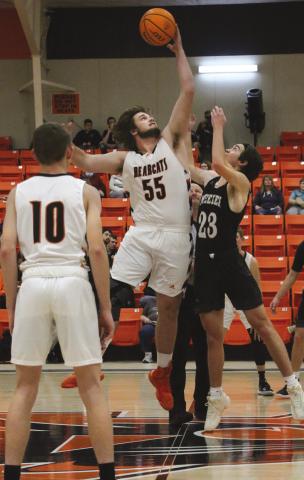 Agra Bearcat Bryson Howard wins the tip off agains Meeker Bulldog Ean Watham Bearcats game against the Dawgs during the Agra invitation tournament Friday, Dec. 9.