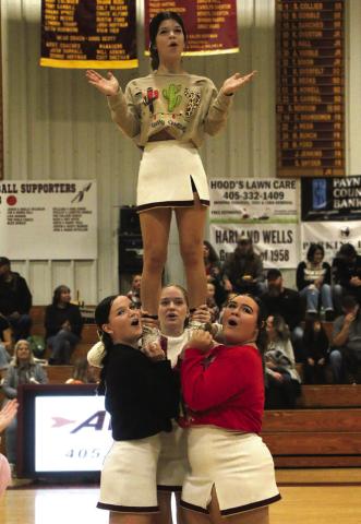 Ripley cheerleaders Tristan Cooper, Taylor Knight, and Annabel Head support Jazmine Toews during the halftime performance at Ripley’s Christmas themed face off with the Earlsboro Wildcats Tuesday, Dec. 19.