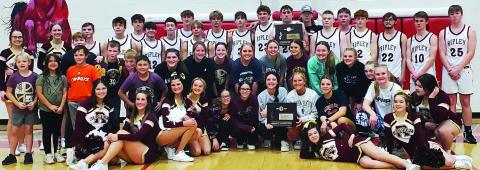 Ripley Warriors and Lady Warriors both stand with their Regional Consolation Championship placards after the Ripley warriors game against the Garber Wolverines Saturday, Feb. 18. The Warriors beat Garber 43-42 with a half court buzzer beater shot. Lady Warriors beat Hominy 41-29. Both teams will play Oklahoma Bible Academy in the first round of the OSSAA Class A Area Tournament at the Stride Bank Event Center in Enid Thursday, Feb. 23. Girls play at 6 p.m. with boys game to follow.