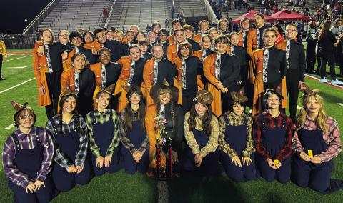 The Cushing Tiger Marching Band stands with their 3rd place trophy after the preliminary round at the Bixby Tournament of Bands.